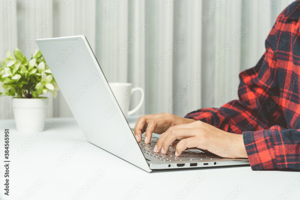 Fototapeta premium Close up. Hands typing keyboard on white laptop in office.