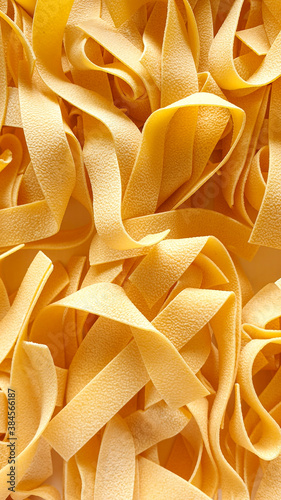 Dried pappardelle pasta closeup background -  Italian food ingredient
