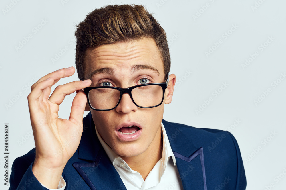 Business man wearing glasses blue suit cropped view official light background