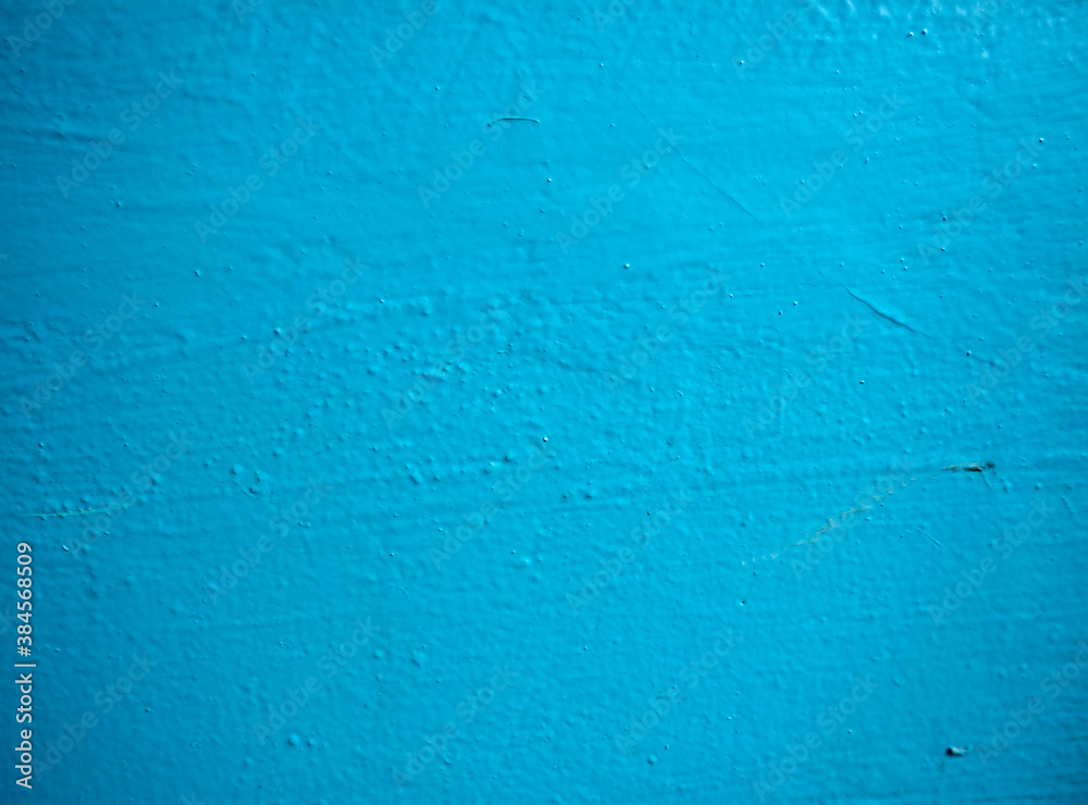 Entrance wall in blue paint. Texture of blue paint on cement and plaster