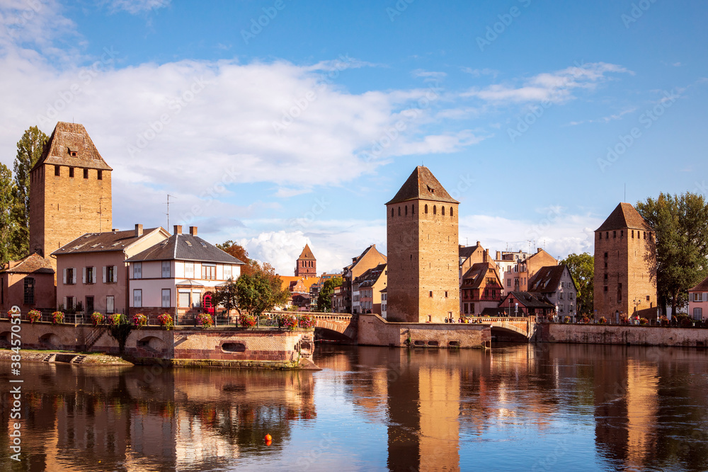 Ponts Couverts in Strasbourg. View on the towers reflecting in water, picturesque landscape of Strasbourg city by the canal, Alsace, France.