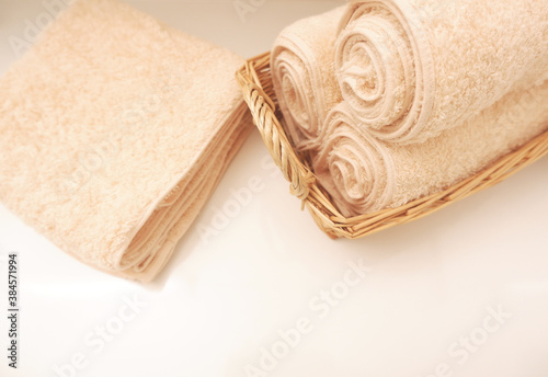 Fresh and clean fluffy towels on table in bathroom, 洗面台に清潔なタオル	 photo