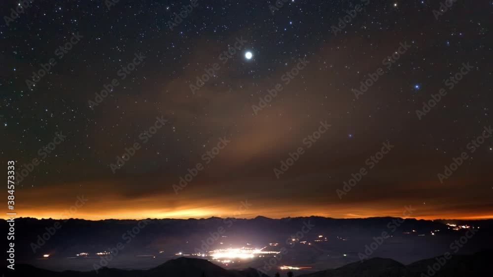 Amazing time-lapse of the night sky rotating above a small town.