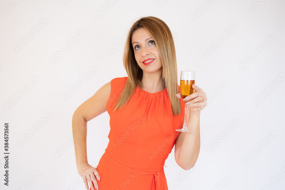 Young celebrating woman red dress. Beautiful model portrait isolated over studio background hold wine glass.