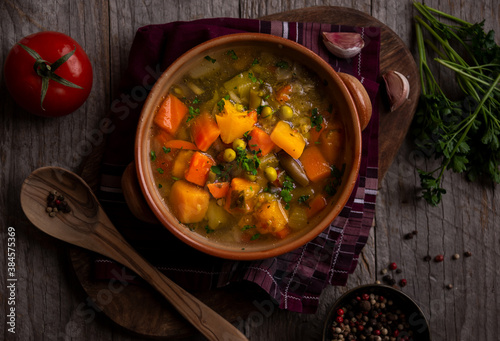 Vegetable soup with parsley on dark background