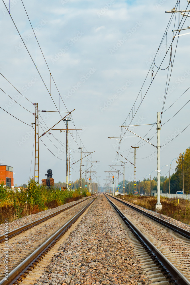 Two lane railroad with electric power lines