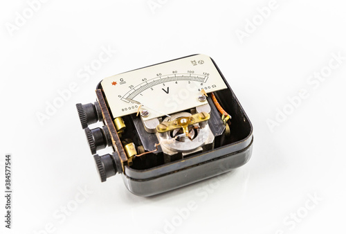 an opened vintage Voltmeter isolated on a white background photo