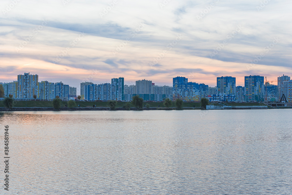 Beautiful modern cityscape. Buildings near the water on sunset