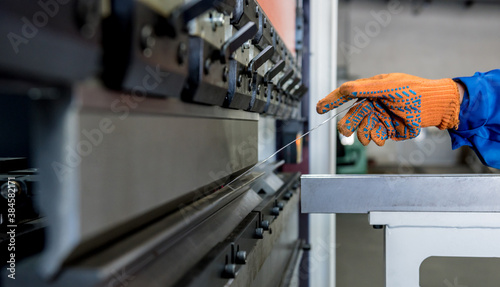 The technician operator use hydraulic bending machine photo