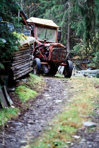 Old tractor in the forest resting. 