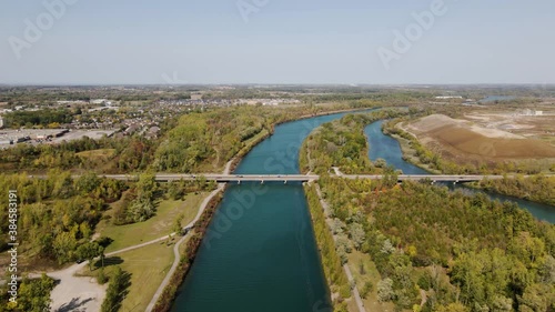 Traffic on the bridge across the river and a canal. Cars crossing the bridge across the Welland canal connecting Lake Ontario and Lake Erie. photo