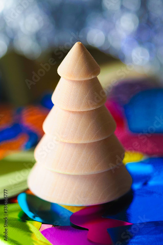 Christmas and New Year holidays background. Wooden xmas tree, colorful sparkle abstract background