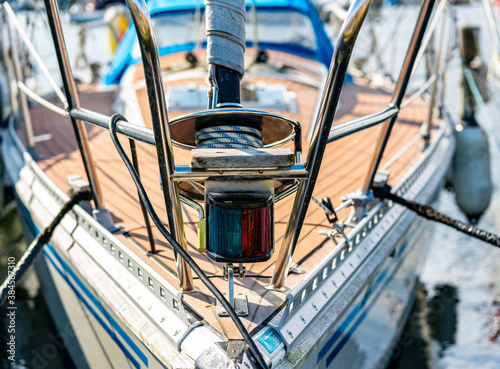 Canvas-taulu Close up of the bow of a sail boat moored in a marina, with lines, ropes and navigational lantern in focus