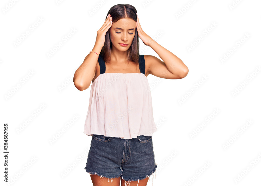 Young hispanic woman wearing casual clothes with hand on head for pain in head because stress. suffering migraine. Young hispanic woman wearing casual clothes with hand on head for pain in head because stress. suffering migraine.