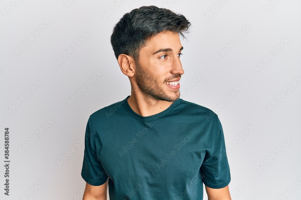 Young handsome man wearing casual clothes looking to side, relax profile pose with natural face and confident smile. Young handsome man wearing casual clothes looking to side, relax profile pose with natural face and confident smile.
