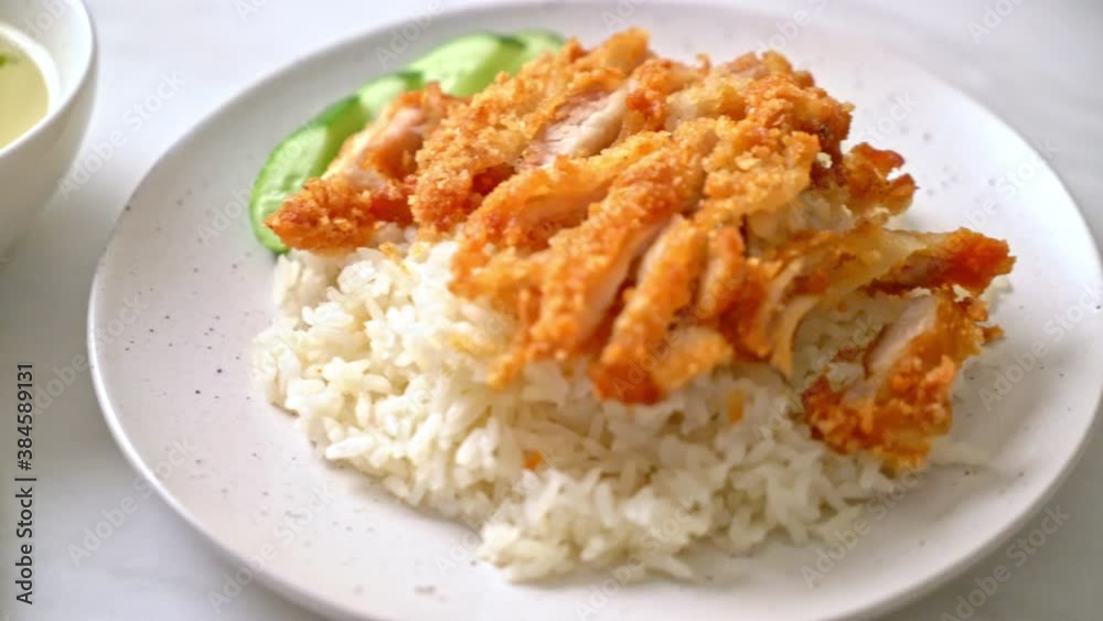 Hainanese chicken rice with fried chicken or rice steamed chicken soup with fried chicken - Asian food style Hainanese chicken rice with fried chicken or rice steamed chicken soup with fried chicken - Asian food style