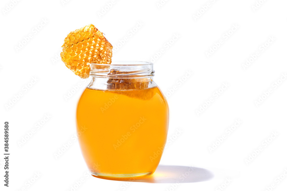 Glass can full of honey and Honeycomb in her isolated on white background Glass can full of honey and Honeycomb in her isolated on white background
