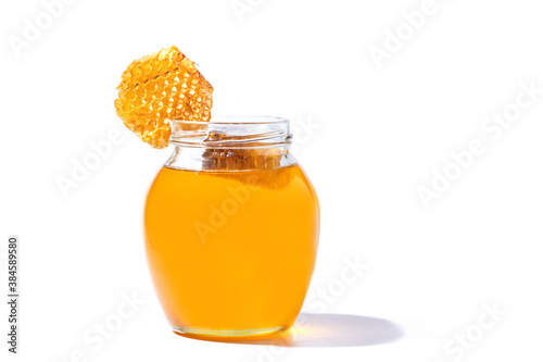Glass can full of honey and Honeycomb in her isolated on white background