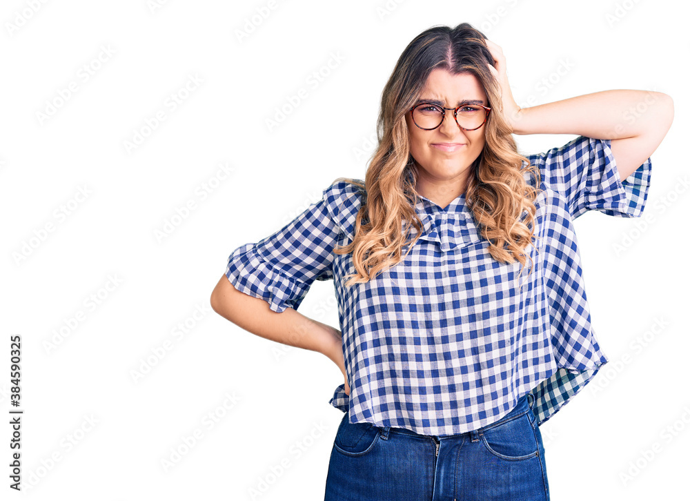Young caucasian woman wearing casual clothes confuse and wonder about question. uncertain with doubt, thinking with hand on head. pensive concept. Young caucasian woman wearing casual clothes confuse and wonder about question. uncertain with doubt, thinking with hand on head. pensive concept.