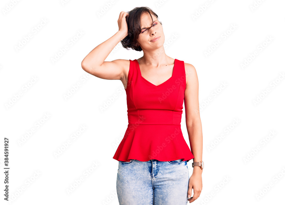 Beautiful young woman with short hair wearing casual style with sleeveless shirt confuse and wondering about question. uncertain with doubt, thinking with hand on head. pensive concept. Beautiful young woman with short hair wearing casual style with sleeveless shirt confuse and wondering about question. uncertain with doubt, thinking with hand on head. pensive concept.
