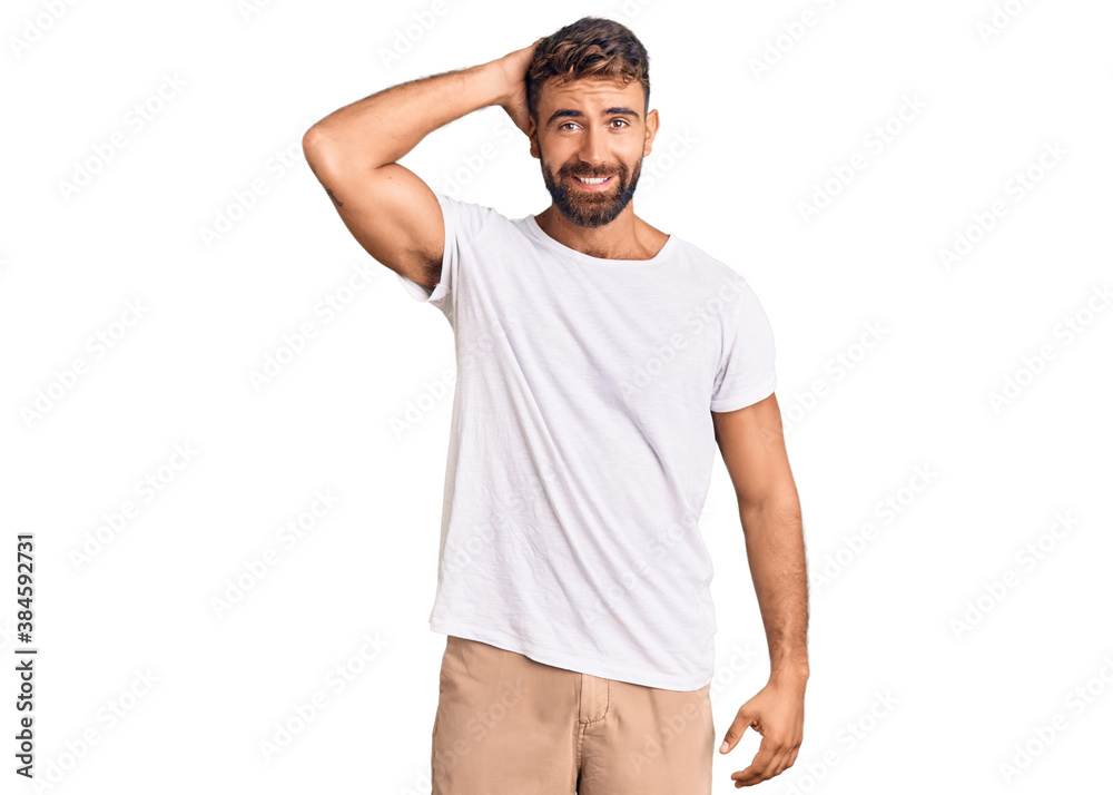 Young hispanic man wearing casual white tshirt confuse and wonder about question. uncertain with doubt, thinking with hand on head. pensive concept.