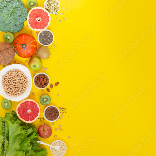 Superfoods on yellow background with copy space. Vegetables  fruits  herbs and seeds