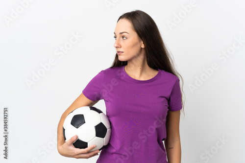 Young hispanic woman over isolated white background with soccer ball © luismolinero