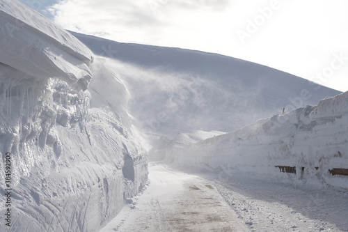 Mountain road with snow and wind