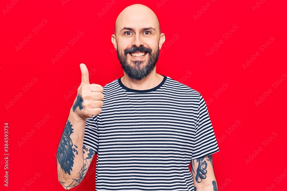 Fototapeta premium Young handsome man wearing casual clothes smiling happy and positive, thumb up doing excellent and approval sign
