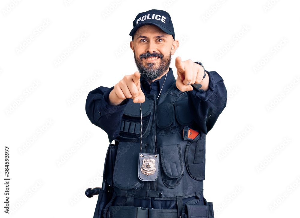 Young handsome man wearing police uniform pointing to you and the camera with fingers, smiling positive and cheerful Young handsome man wearing police uniform pointing to you and the camera with fingers, smiling positive and cheerful