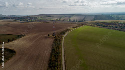 Aerial view of Czech landscape and transmitter between fields and meadows.
