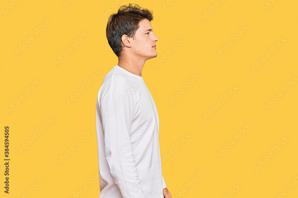 Handsome caucasian man wearing casual white sweater looking to side, relax profile pose with natural face and confident smile. Handsome caucasian man wearing casual white sweater looking to side, relax profile pose with natural face and confident smile.