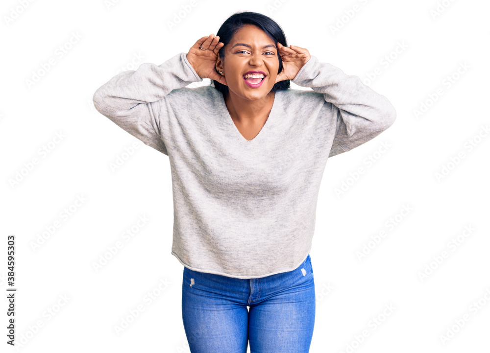 Naklejka premium Hispanic woman with long hair wearing casual clothes trying to hear both hands on ear gesture, curious for gossip. hearing problem, deaf