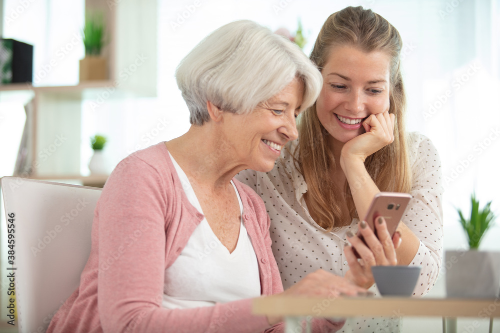 mother with daughter sitting on sofa using social media mother with daughter sitting on sofa using social media