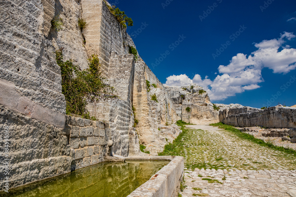 Gravina in Puglia, Italy. The path of pebbles and stones that leads to the Sanctuary of the Madonna della Stella. The large tub, drinking trough, full of water.
