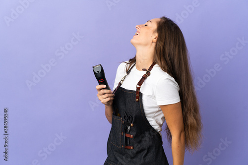 Young hairdresser woman over isolated background laughing in lateral position
