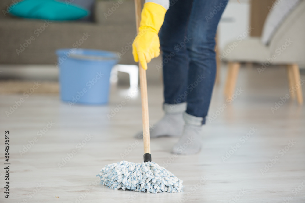 woman is mopping the floor - obrazy, fototapety, plakaty 