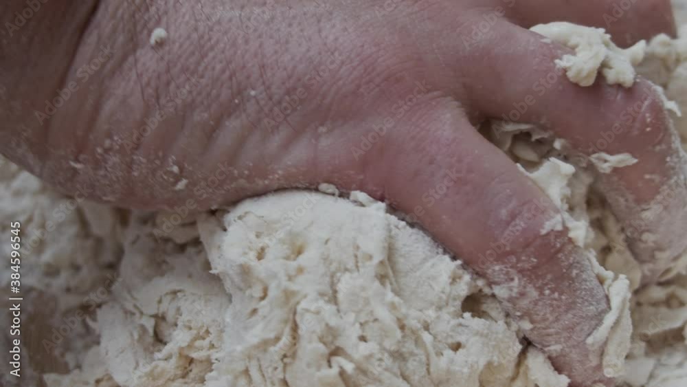 Chef molds the pizza dough in a deep plate, on a wooden table. Hands extreme close up. Pizza making recipe. Slow motion. Chef molds the pizza dough in a deep plate, on a wooden table. Hands extreme close up. Pizza making recipe. Slow motion.