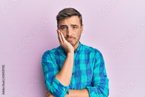 Handsome caucasian man wearing casual clothes thinking looking tired and bored with depression problems with crossed arms.