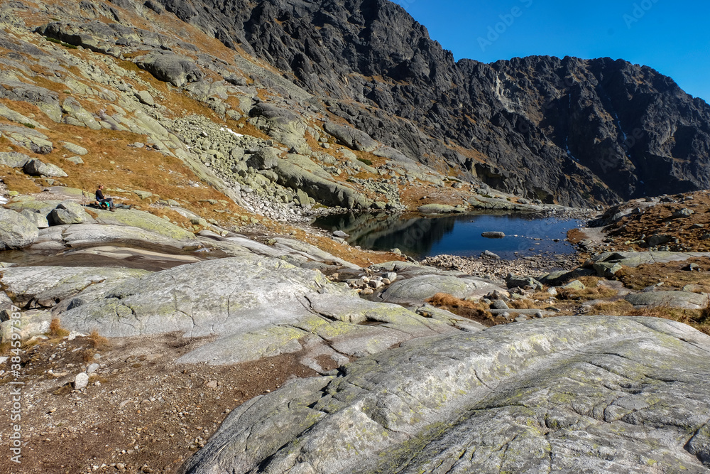 Pond in Valley of Five Spis Lakes surrounded by rocky summits, High Tatra Mountains, Slovakia. Pond in Valley of Five Spis Lakes surrounded by rocky summits, High Tatra Mountains, Slovakia.
