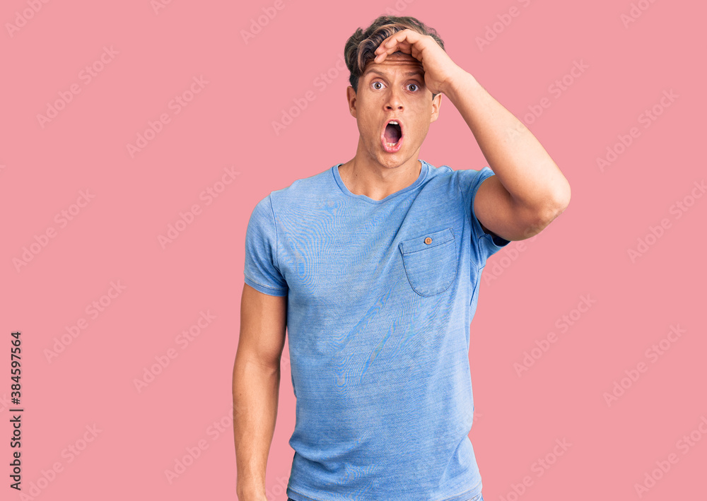 Young handsome man wearing casual clothes surprised with hand on head for mistake, remember error. forgot, bad memory concept. Young handsome man wearing casual clothes surprised with hand on head for mistake, remember error. forgot, bad memory concept.