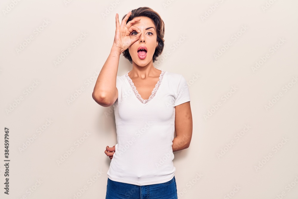 Young beautiful woman wearing casual clothes doing ok gesture shocked with surprised face, eye looking through fingers. unbelieving expression. Young beautiful woman wearing casual clothes doing ok gesture shocked with surprised face, eye looking through fingers. unbelieving expression.
