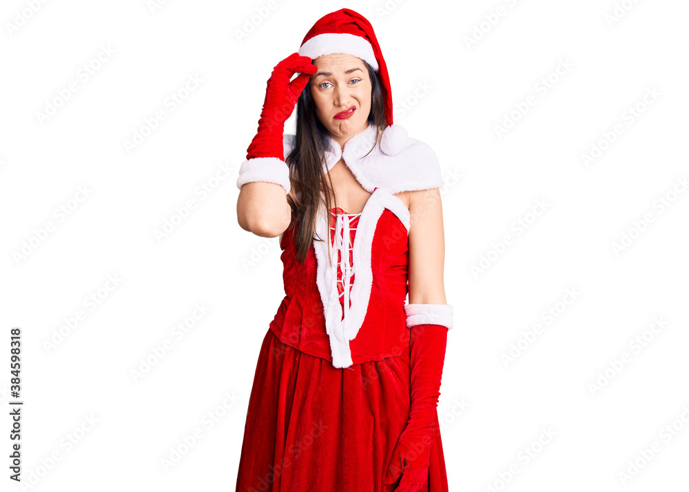 Young beautiful caucasian woman wearing santa claus costume worried and stressed about a problem with hand on forehead, nervous and anxious for crisis Young beautiful caucasian woman wearing santa claus costume worried and stressed about a problem with hand on forehead, nervous and anxious for crisis