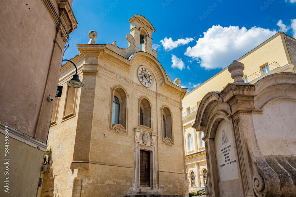 Fototapeta premium Gravina in Puglia, Italy. A glimpse of the main square of the ancient city, overlooked by the library. The large fountain in the center.