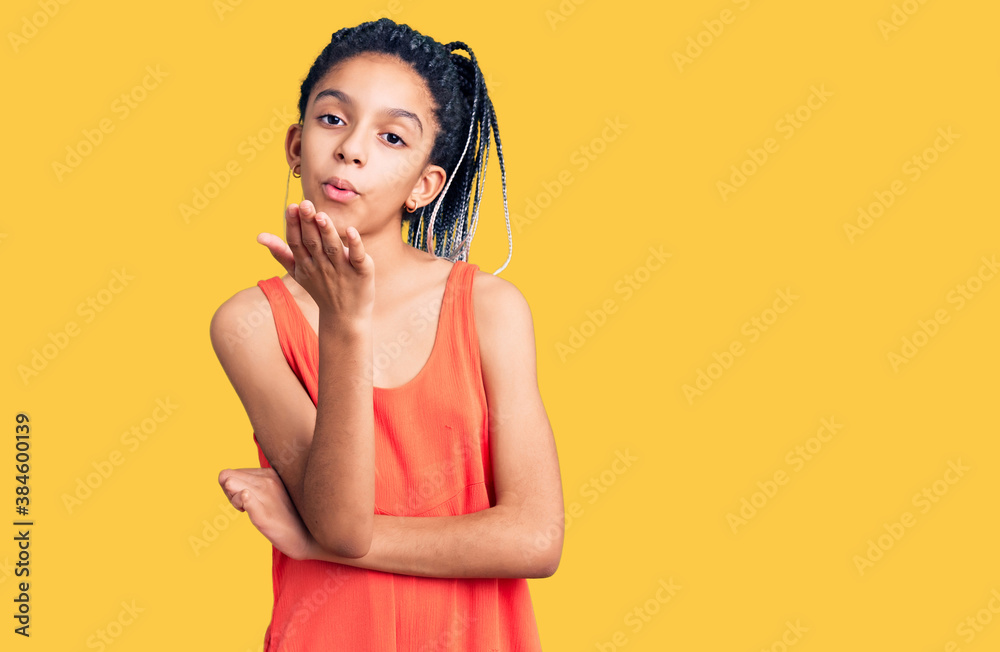 Cute african american girl wearing casual clothes looking at the camera blowing a kiss with hand on air being lovely and sexy. love expression.