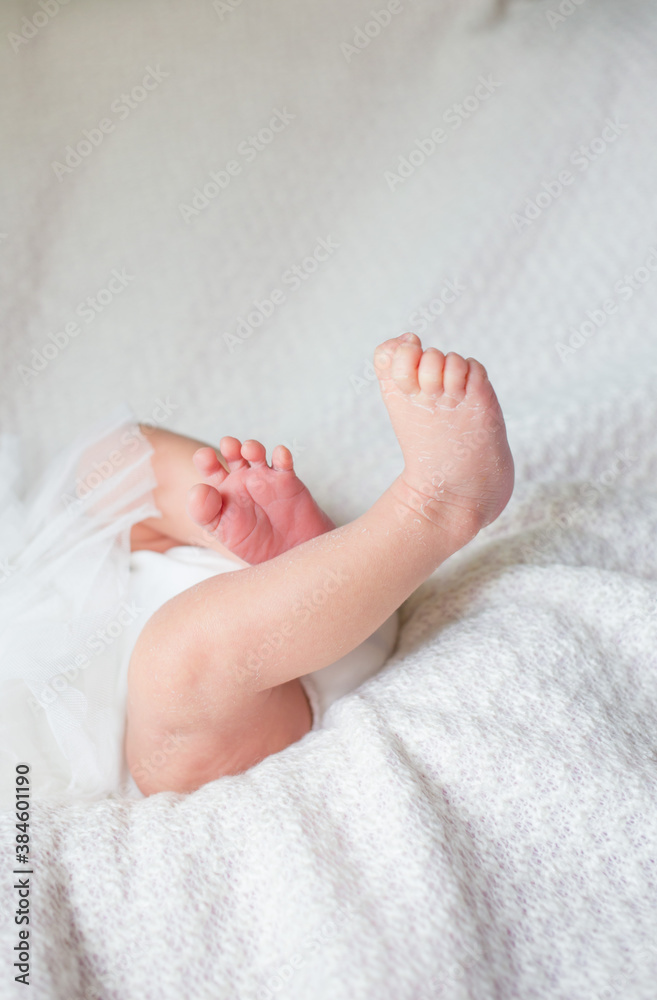 Newborn baby feet on a white blanket. Newborn baby feet on a white blanket.