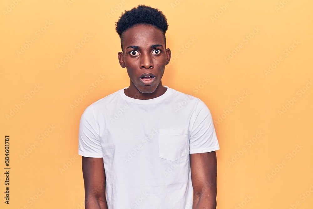 Young african american man wearing casual clothes afraid and shocked with surprise and amazed expression, fear and excited face. Young african american man wearing casual clothes afraid and shocked with surprise and amazed expression, fear and excited face.