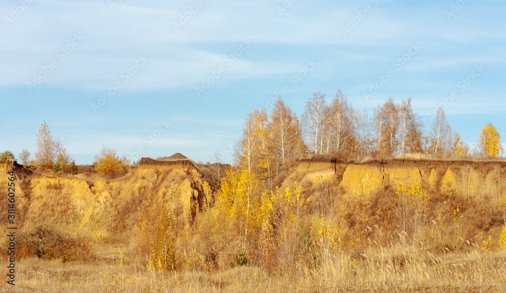 Autumn landscape on the slopes of a sandy steep.