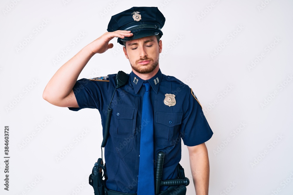 Young caucasian man wearing police uniform worried and stressed about a problem with hand on forehead, nervous and anxious for crisis Young caucasian man wearing police uniform worried and stressed about a problem with hand on forehead, nervous and anxious for crisis