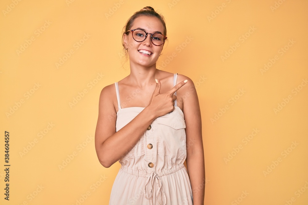 Obraz premium Beautiful caucasian woman wearing summer dress cheerful with a smile of face pointing with hand and finger up to the side with happy and natural expression on face